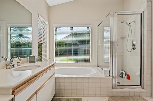 bathroom with vanity, independent shower and bath, and lofted ceiling