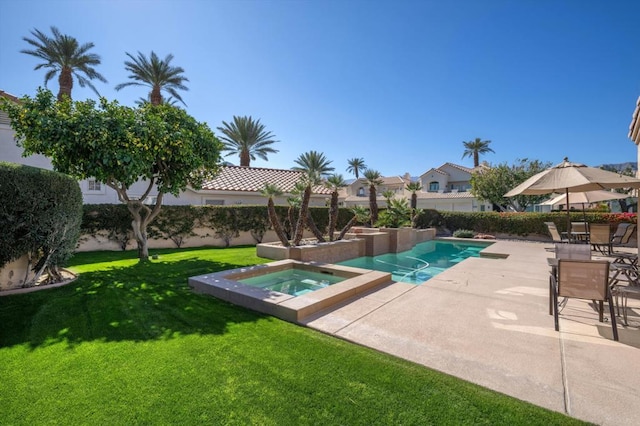 view of pool featuring an in ground hot tub, a yard, and a patio