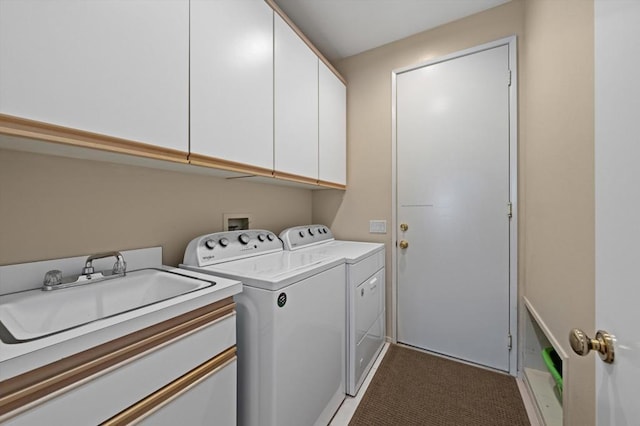 laundry area with cabinets, separate washer and dryer, and sink