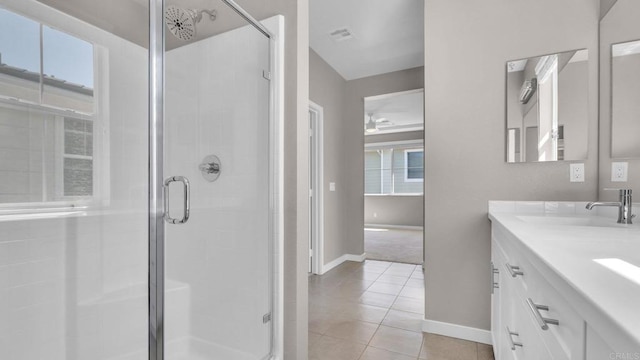 bathroom with tile patterned flooring, vanity, and a shower with shower door