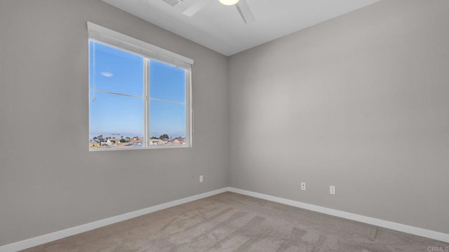 carpeted spare room with ceiling fan