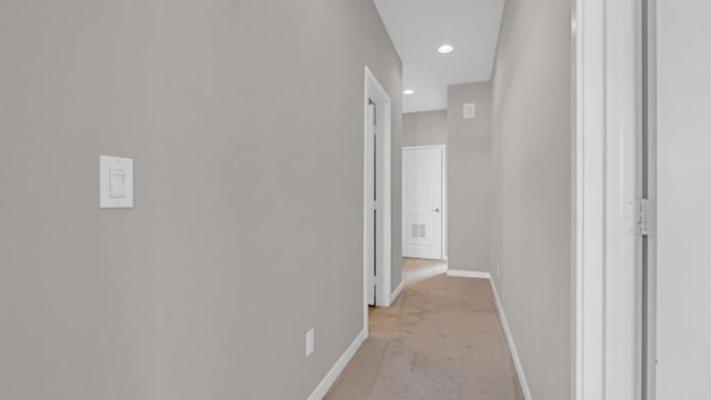 corridor featuring light colored carpet