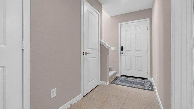 doorway with light tile patterned floors