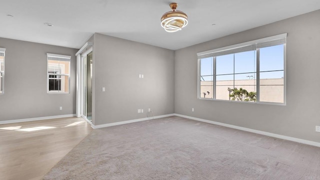 empty room with a healthy amount of sunlight and wood-type flooring