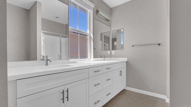 bathroom with tile patterned floors, a wealth of natural light, and vanity