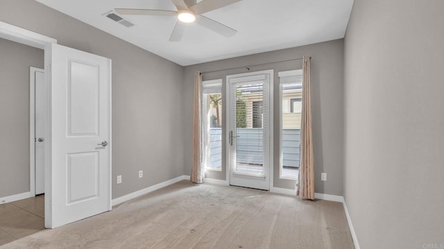 carpeted empty room featuring ceiling fan