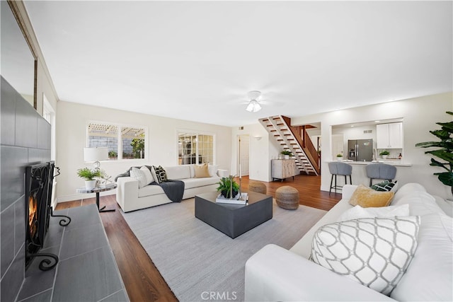 living room with ceiling fan and hardwood / wood-style floors