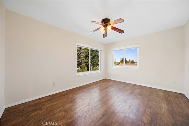 unfurnished room with ceiling fan and dark wood-type flooring