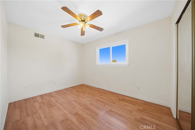 unfurnished bedroom with ceiling fan, a closet, and light hardwood / wood-style floors