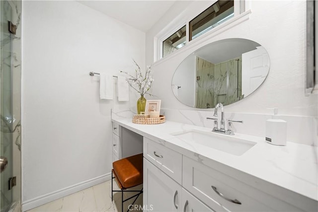 bathroom featuring a shower with door and vanity