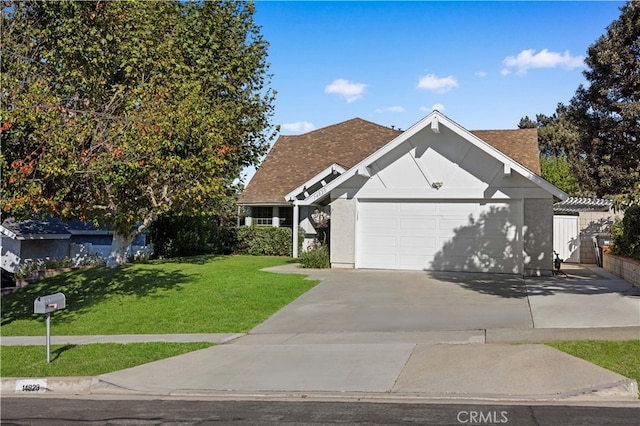 view of front of home with a front lawn and a garage