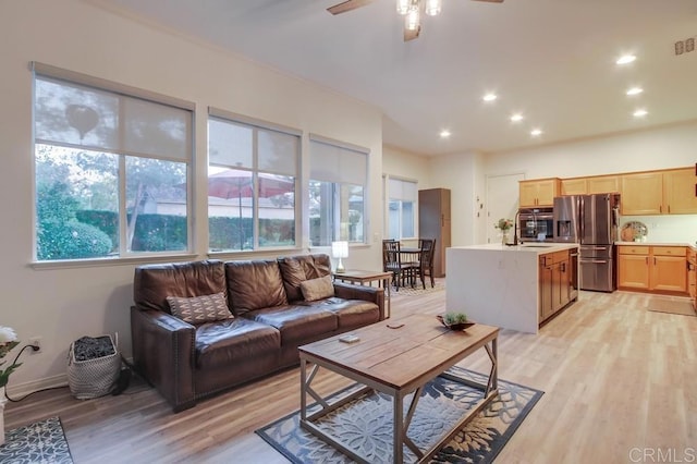 living room with light wood-type flooring and ceiling fan