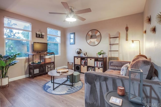 living room with wood-type flooring and ceiling fan