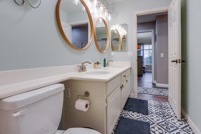 bathroom with hardwood / wood-style flooring, vanity, and toilet