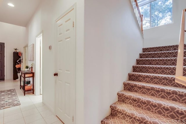 stairs featuring tile patterned flooring