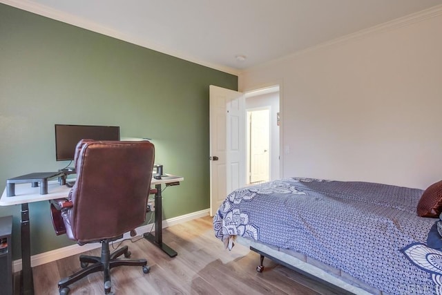 bedroom with light hardwood / wood-style floors and ornamental molding