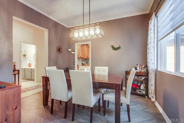 dining space featuring parquet flooring and crown molding