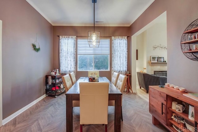 dining space featuring light parquet floors and ornamental molding