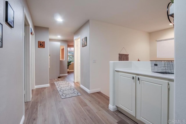 corridor with light hardwood / wood-style flooring