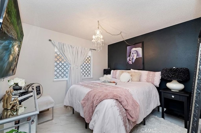 bedroom with a textured ceiling and an inviting chandelier