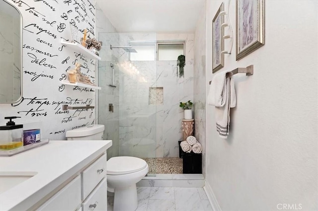 bathroom with vanity, toilet, and tiled shower