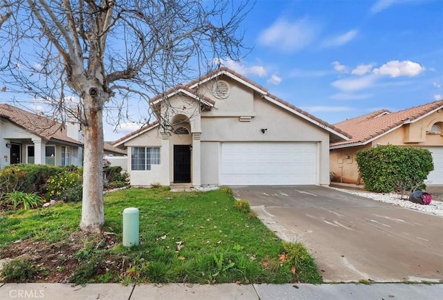 view of front of home with an attached garage, a tile roof, a front yard, stucco siding, and driveway