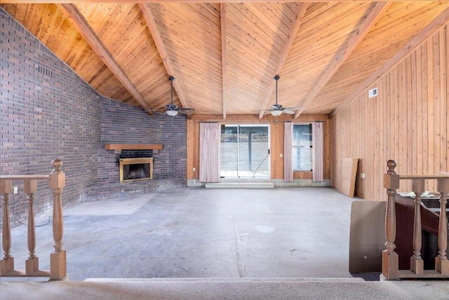 unfurnished living room featuring wooden ceiling, vaulted ceiling with beams, brick wall, wood walls, and concrete floors