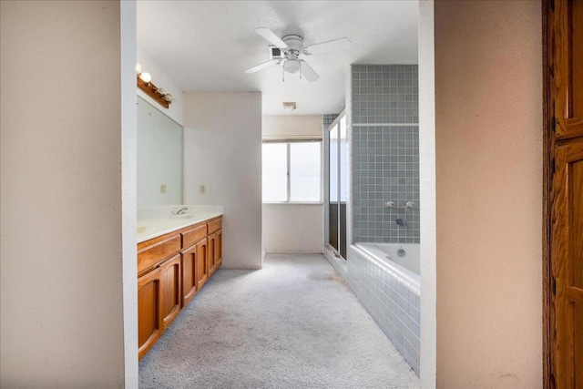 bathroom featuring vanity, ceiling fan, and plus walk in shower