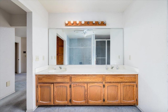 bathroom with vanity and a shower with shower door