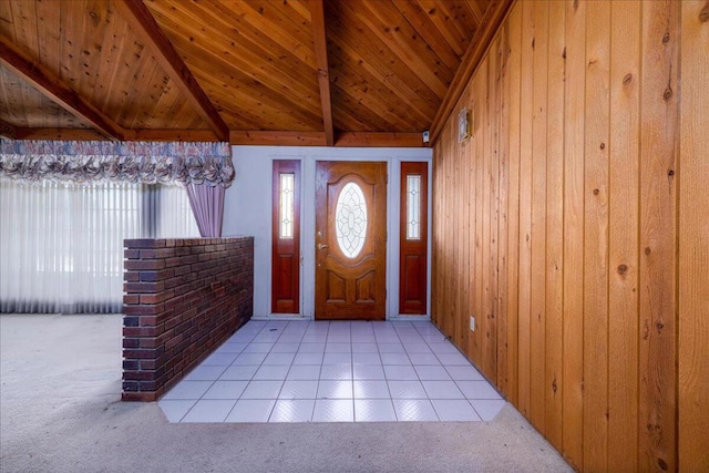 tiled foyer entrance featuring wooden walls, lofted ceiling with beams, and wooden ceiling