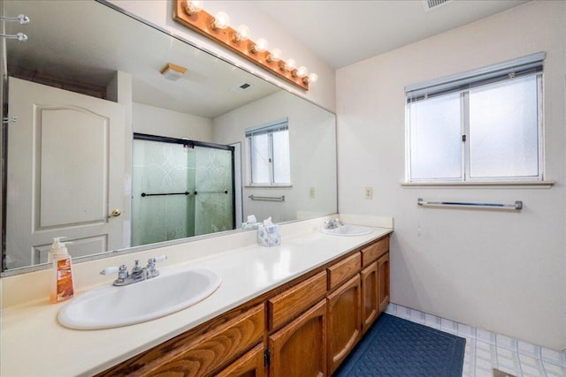 bathroom with a shower with door and vanity