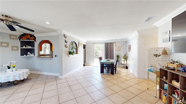 tiled dining room featuring ceiling fan and ornamental molding