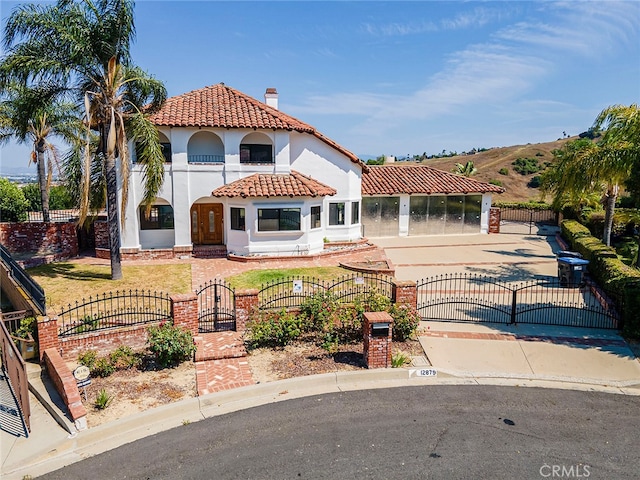 view of front of house with a balcony and a front lawn