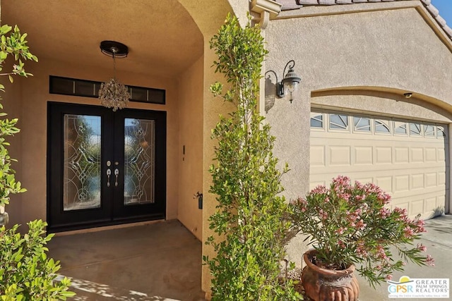 entrance to property featuring french doors and a garage