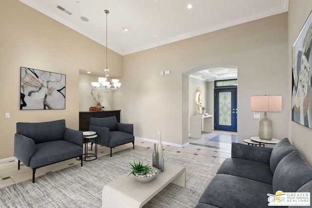 tiled living room with ornamental molding and an inviting chandelier