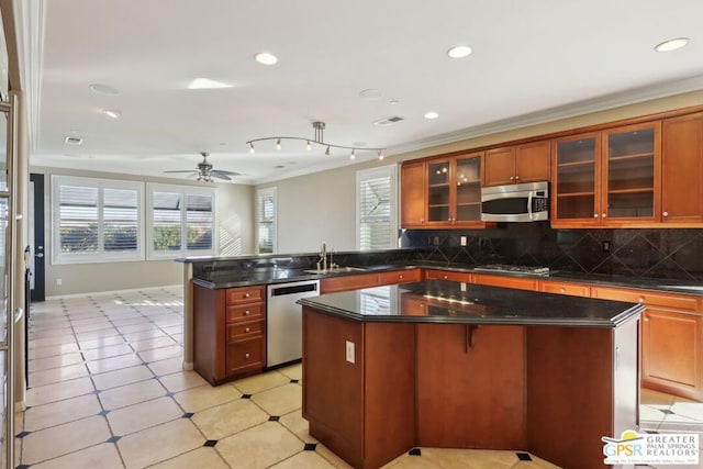 kitchen featuring ornamental molding, stainless steel appliances, and a center island