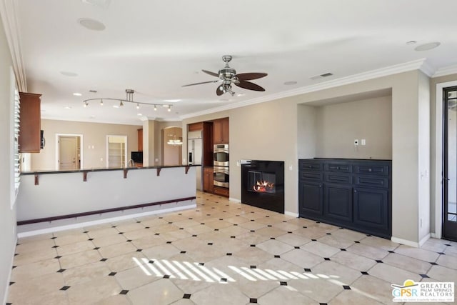 unfurnished living room featuring ornamental molding and ceiling fan