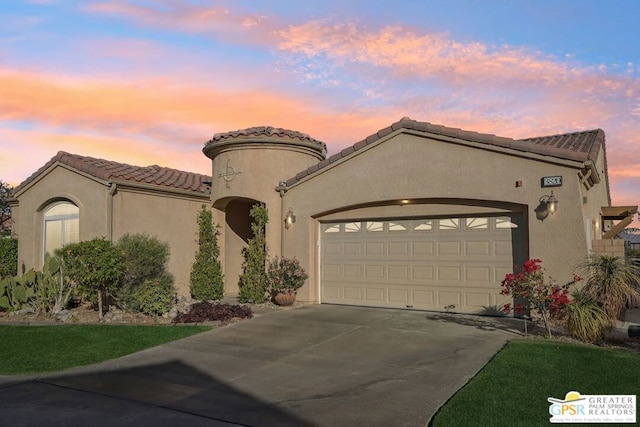 mediterranean / spanish home featuring a garage