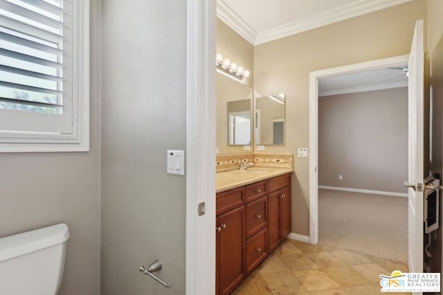 bathroom featuring vanity, crown molding, and toilet