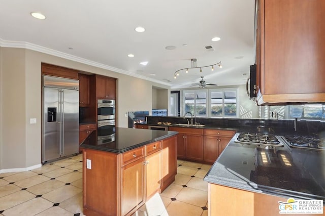 kitchen featuring sink, crown molding, a kitchen island, ceiling fan, and stainless steel appliances