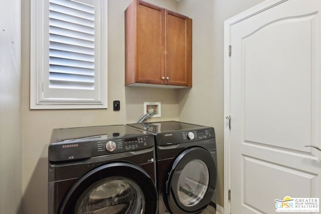 laundry area featuring cabinets and washing machine and clothes dryer