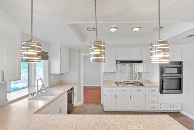 kitchen with pendant lighting, white cabinetry, and sink