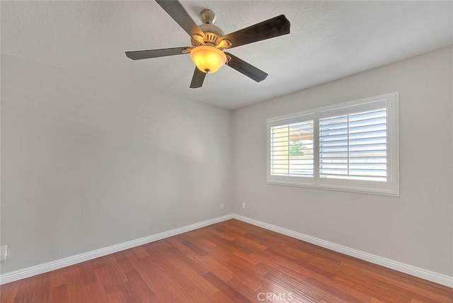 spare room featuring ceiling fan and hardwood / wood-style flooring