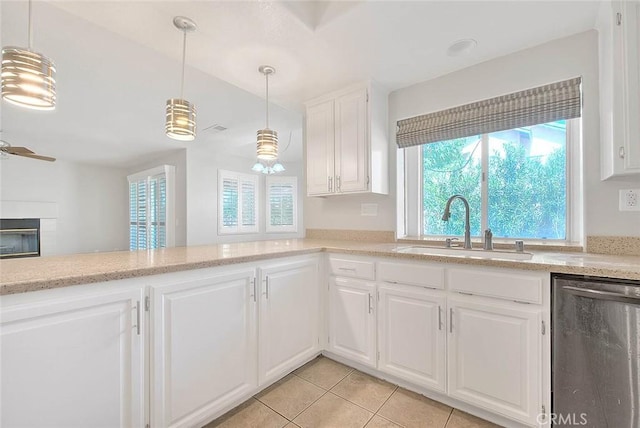 kitchen featuring dishwasher, white cabinets, sink, hanging light fixtures, and ceiling fan