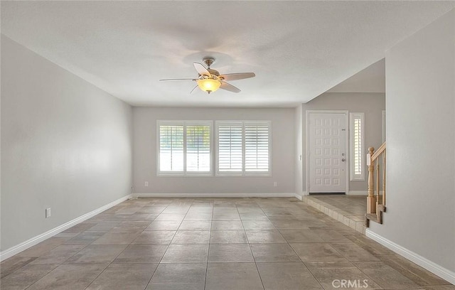 tiled empty room with ceiling fan