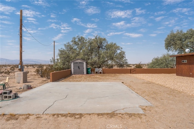 view of patio featuring a storage unit and a mountain view