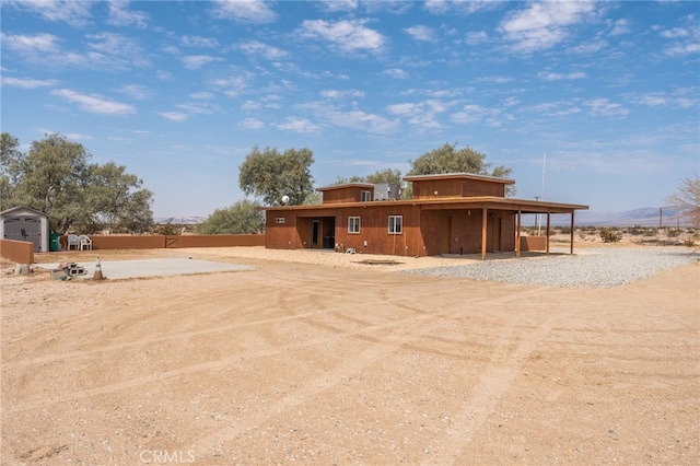 rear view of property featuring an outbuilding