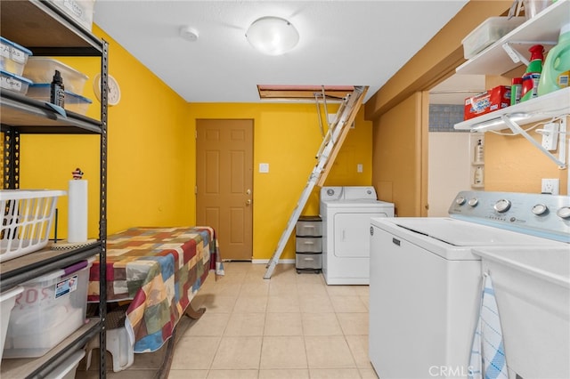 washroom with washer and dryer, sink, and light tile patterned flooring