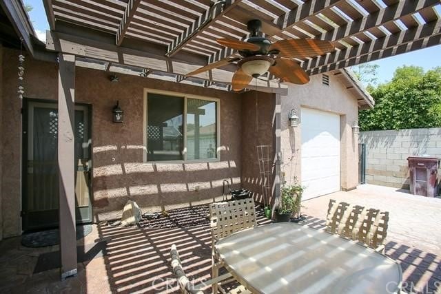 exterior space featuring ceiling fan and a pergola