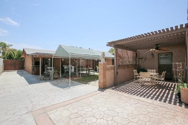 exterior space with ceiling fan, a pergola, and a patio area